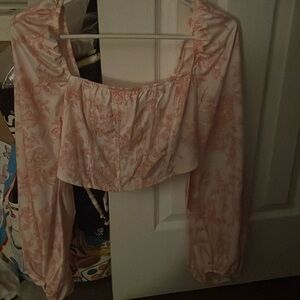 A floral crop top and it is corset like in the front brand new ,good quality